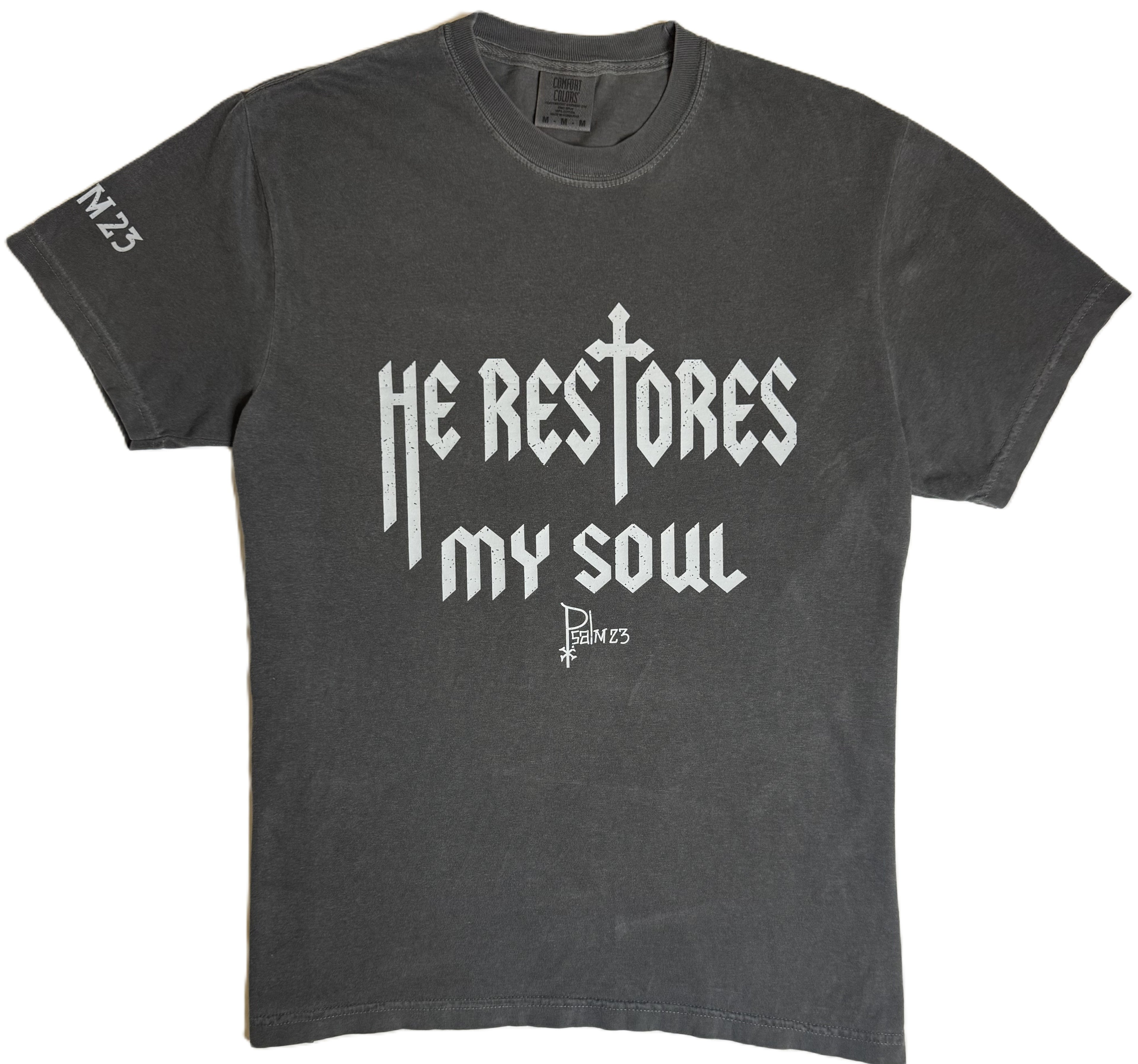 Gray t-shirt with white text 'He Restores My Soul' on a white background